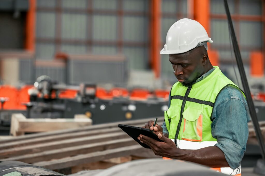 Metal sheet workers perform routine quality checking, enhancing assurance in roofing infrastructure